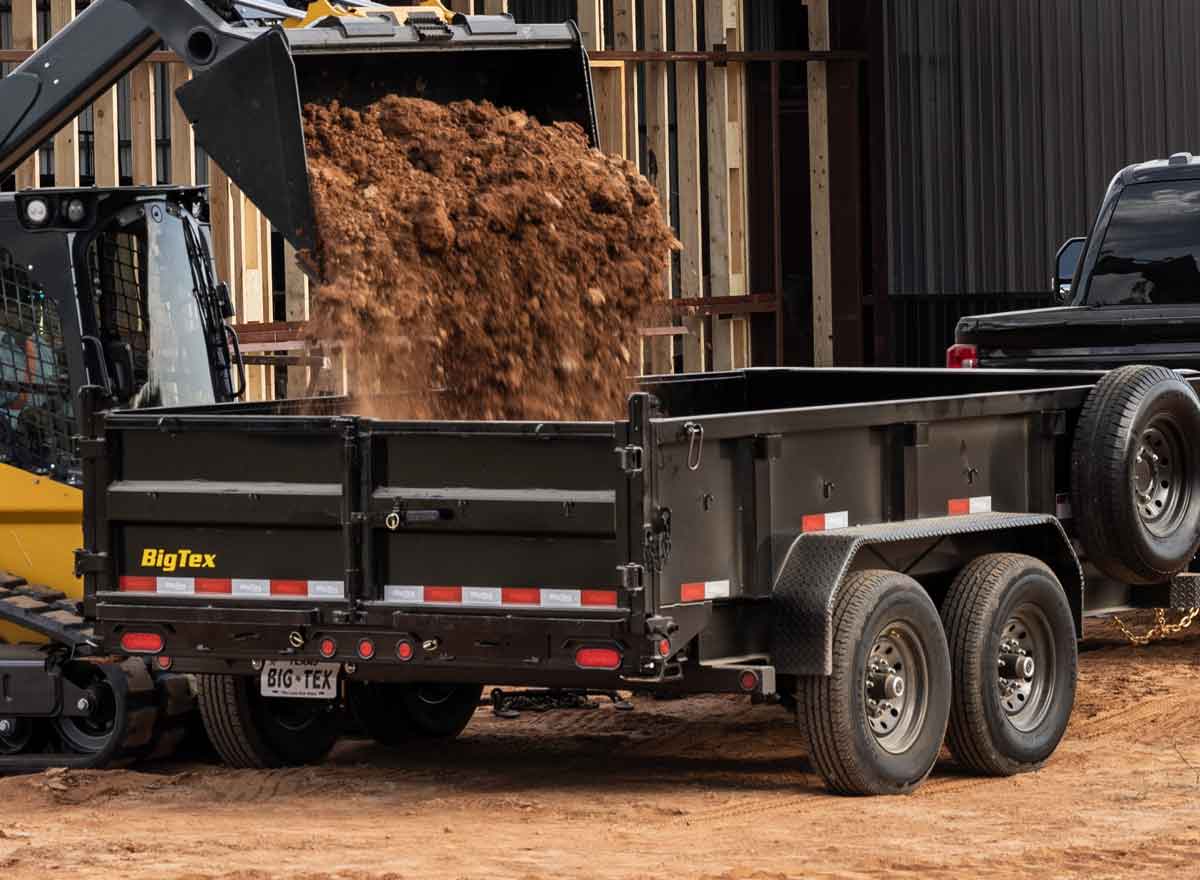 Big Tex Dump Trailer being loaded with dirt